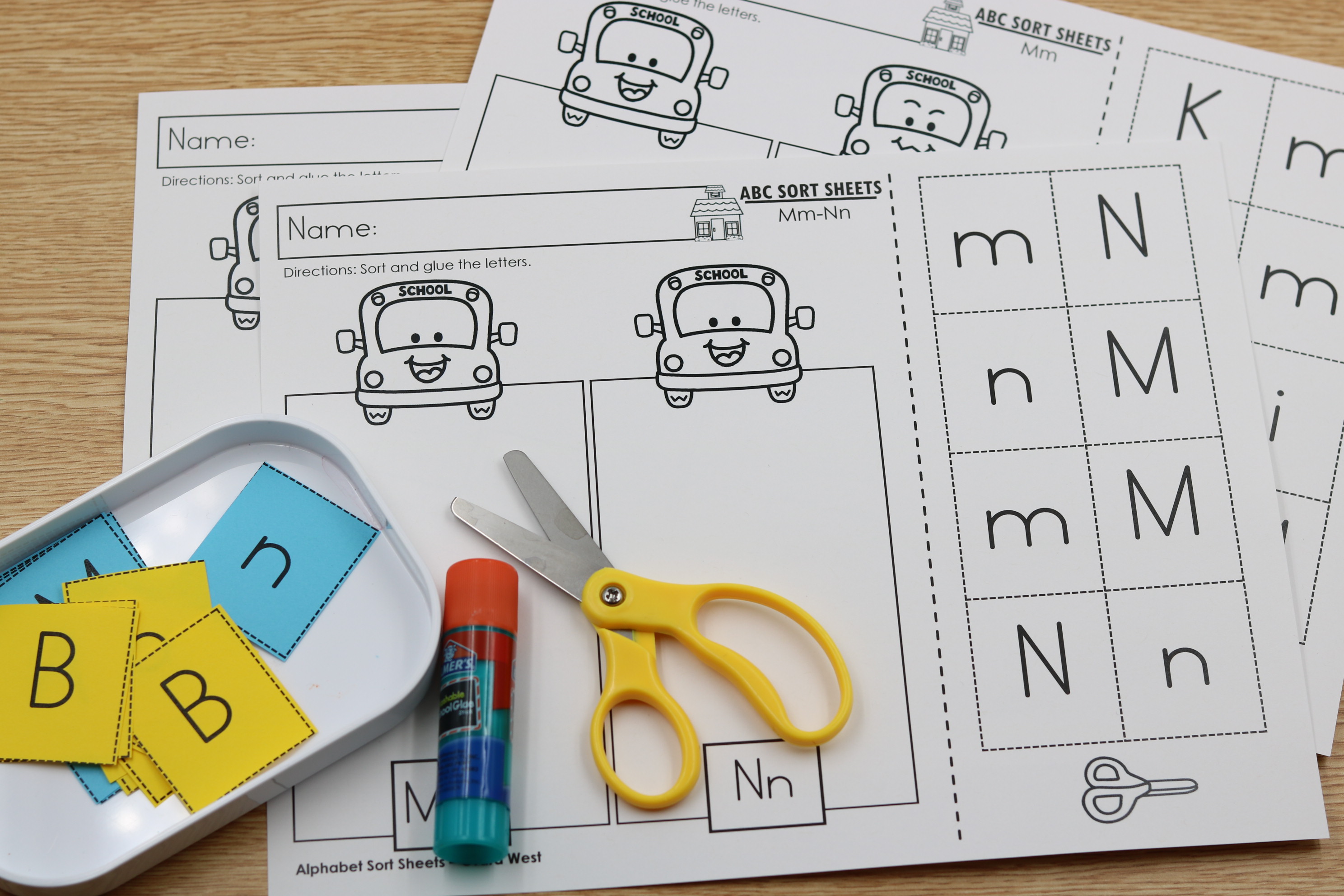 Printable alphabet bus letter sorting sheets with focus letter identification.