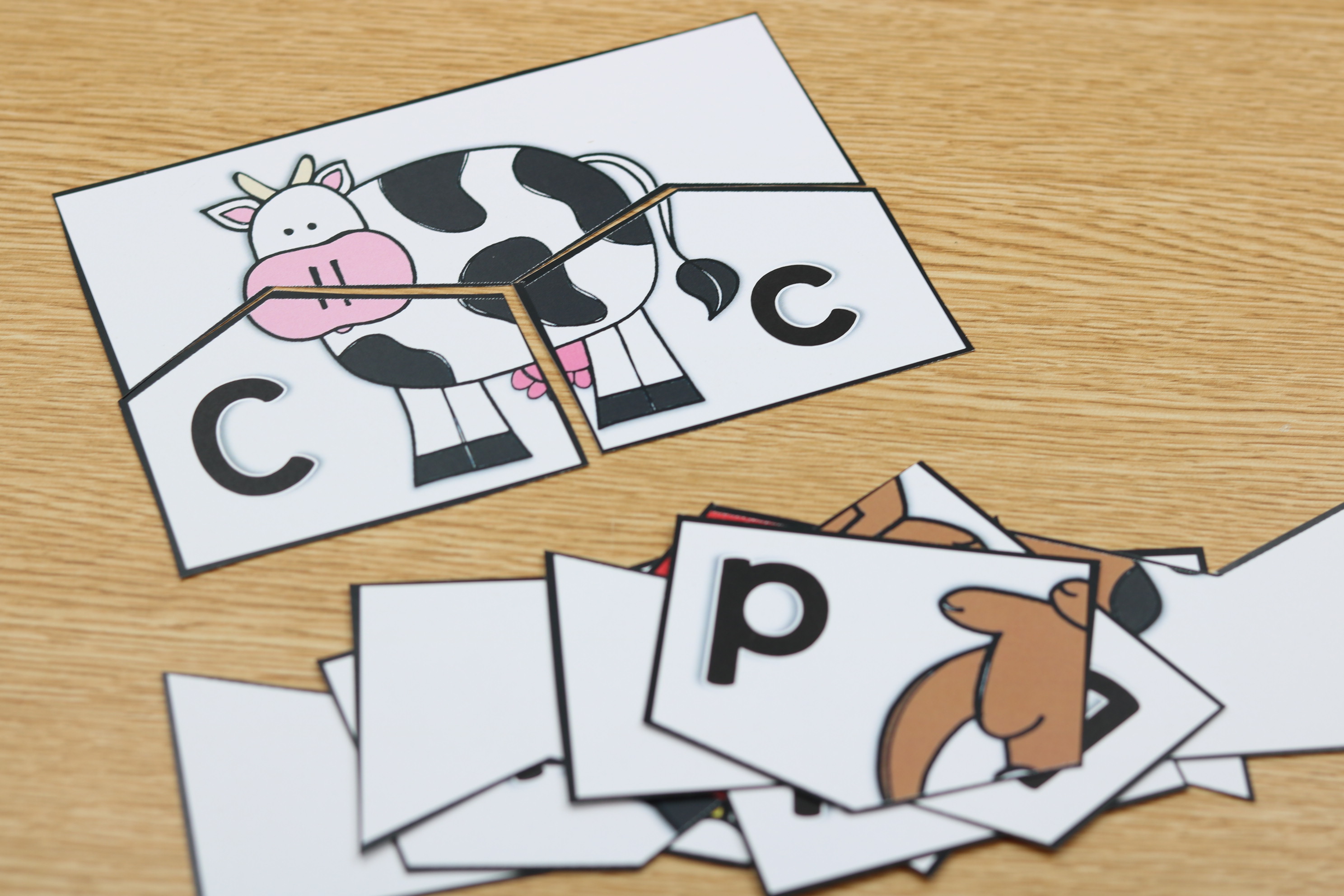 Self-checking alphabet puzzles matching capital and lowercase letters with beginning sound images.