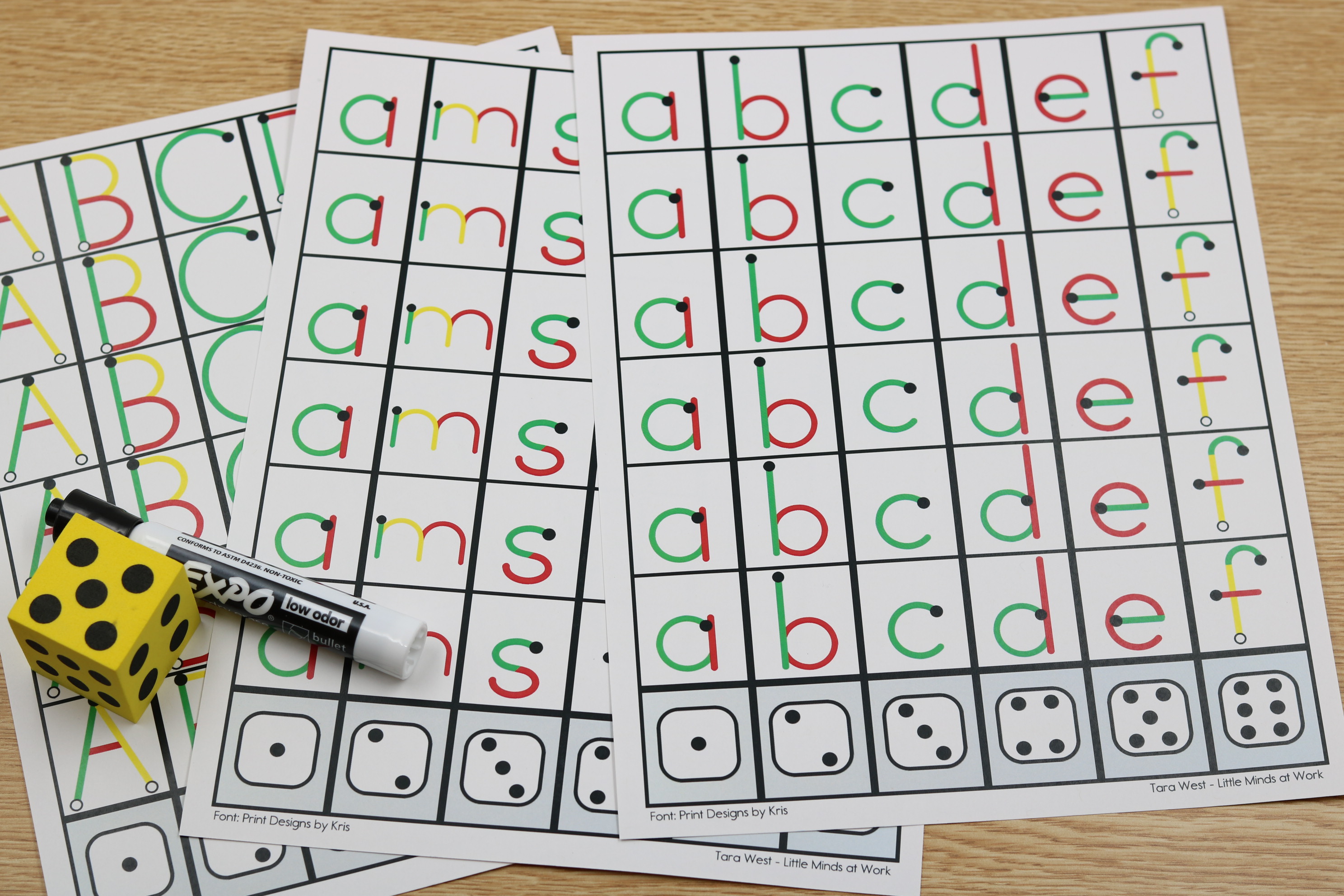 Alphabet roll and trace mat with letter columns for handwriting practice using dice.