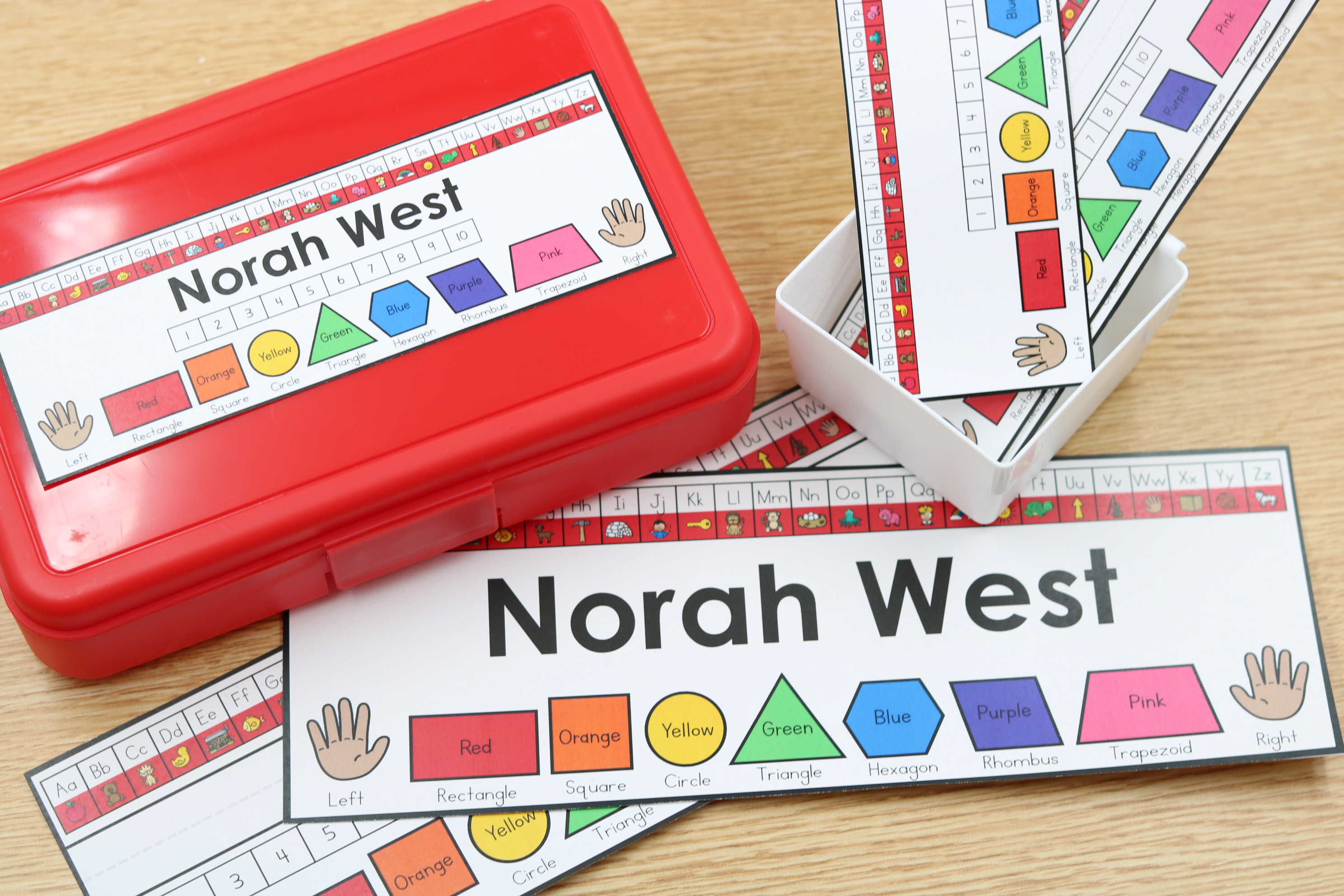 Editable student name tags with ABC strips and hand visuals on a desk